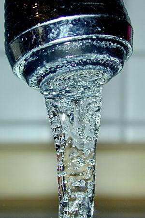 Drinking water poured into a glass